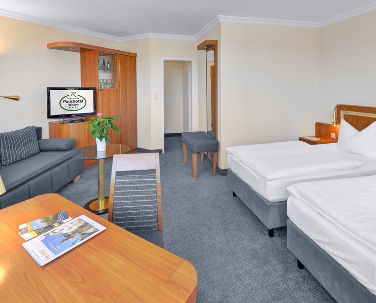Spacious rooms with table, armchair and TV at the 3-star-superior hotel Ringhotel Parkhotel Witten in Witten | © Ringhotel Parkhotel Witten